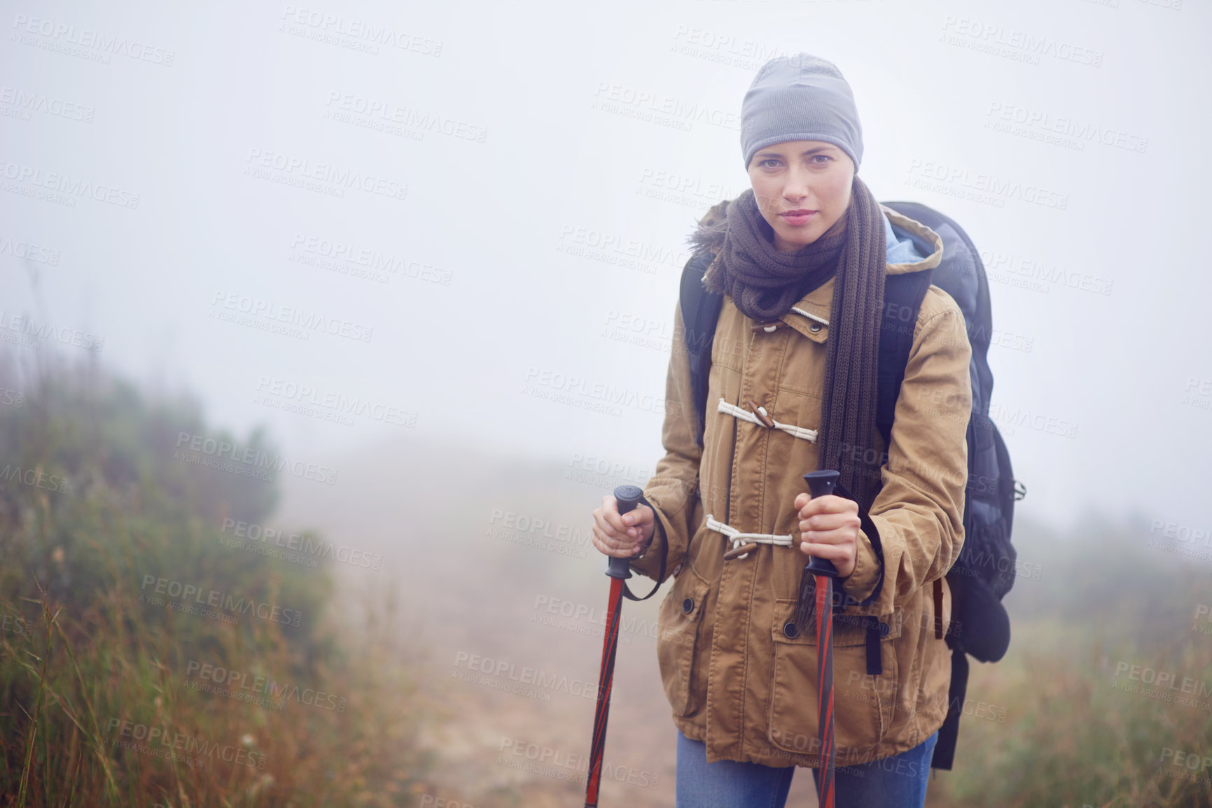 Buy stock photo Portrait of a young woman hiking along a trail on an overcast day