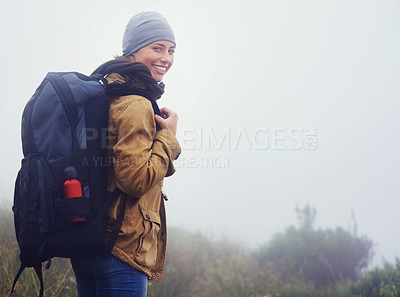 Buy stock photo Portrait of a young woman hiking along a trail on an overcast day