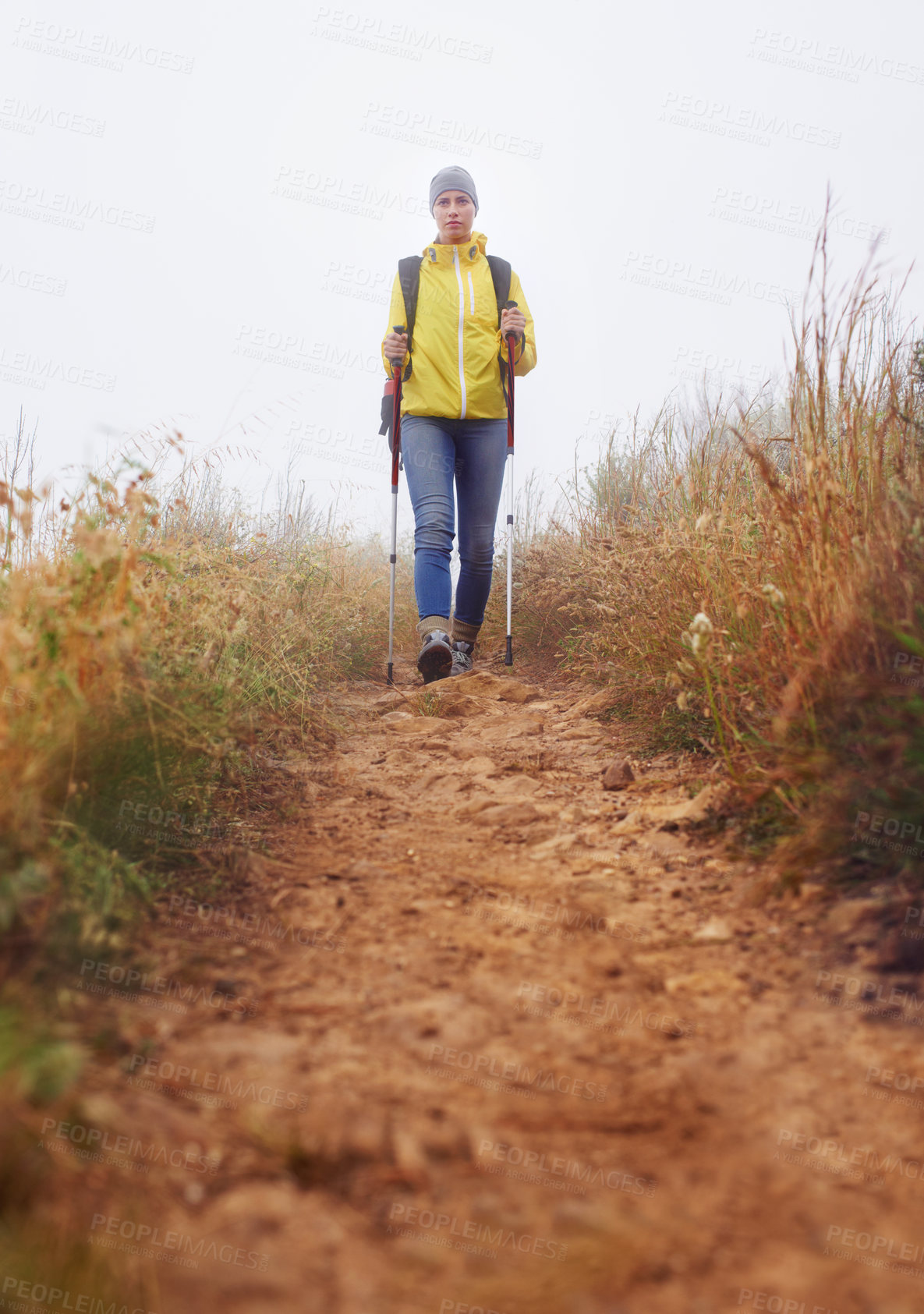 Buy stock photo Woman, hiking and fitness in nature with stick for journey, outdoor adventure and wellness in winter background. Travel, low angle and person in trekking pole for explore, mobility or balance.