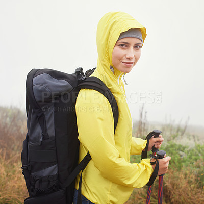 Buy stock photo Portrait, female hiker and fog on mountain trail, exercise and cardio for fitness in nature. Smile, walking stick and gear for training and morning overcast weather, workout and happy or rest on path
