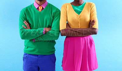 Buy stock photo Cropped studio shot of a two stylishly dressed people standing with their arms crossed