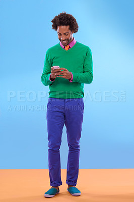 Buy stock photo Studio shot of stylish young man talking on the phone against a colorful background