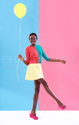 Buy stock photo Woman, balloon and smile with colorful clothes for fashion, trendy and playful for outstanding and bold style. African person, model and happy lady for funky look, retro or different for fun