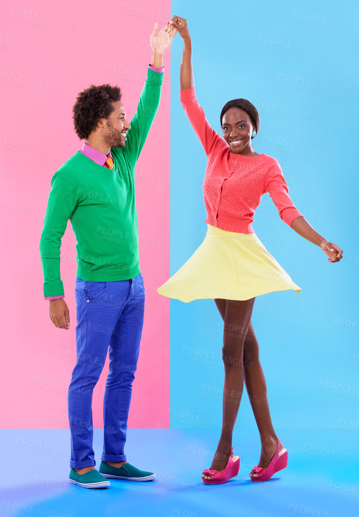 Buy stock photo Happy, dance and couple in studio with fashion and holding hands, spinning and creative portrait. African, woman and man together with colorful retro style, unique clothes or moving with support