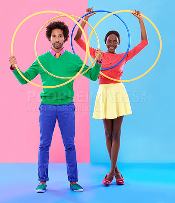 Buy stock photo People, smile or hoop for fashion, casual or spring outfit for playful aesthetic on color block background. Portrait, man or woman for plastic toy in funky, colorful or stylish clothing in studio