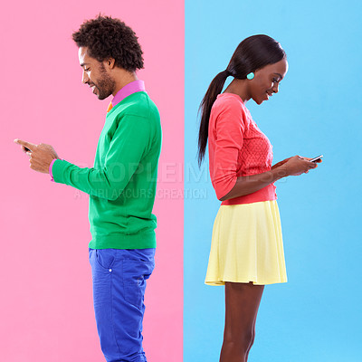 Buy stock photo Studio shot of a young couple using cellphoes standing against a colourful background