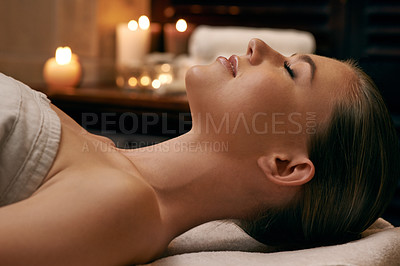 Buy stock photo A young woman lying with her eyes closed on a massage bed