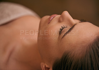 Buy stock photo Woman, lying and relax in spa for luxury or peace, massage therapy or skincare and calm to free tension. Female person, closeup and wellness for stress relief or rest for wellbeing with aromatherapy.