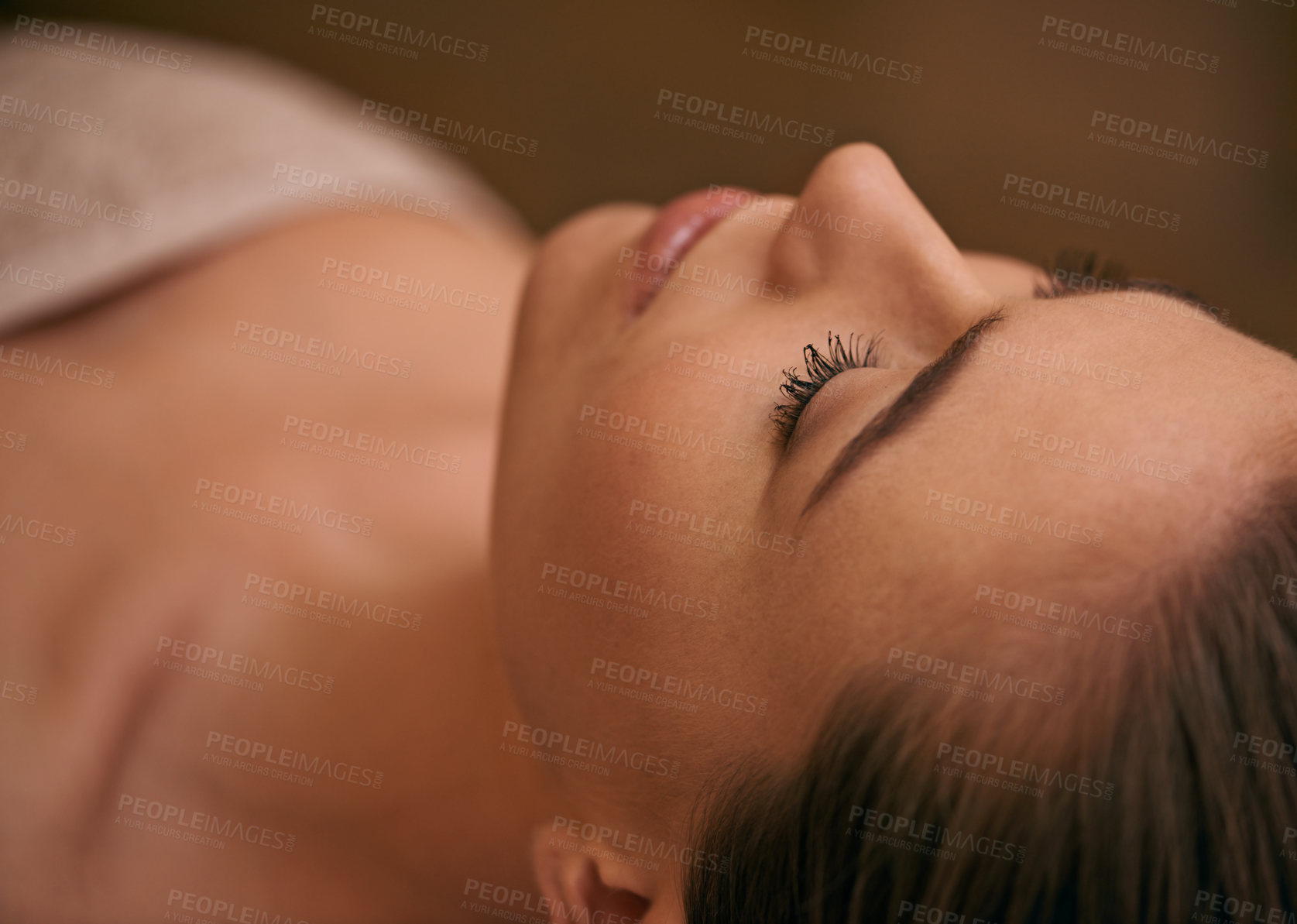 Buy stock photo Woman, lying and relax in spa for luxury or peace, massage therapy or skincare and calm to free tension. Female person, closeup and wellness for stress relief or rest for wellbeing with aromatherapy.