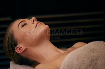 Buy stock photo Woman, lying and relax in spa for wellness or peace, massage therapy or skincare and calm to free tension. Female person, resort and luxury for stress relief or rest for wellbeing with aromatherapy.