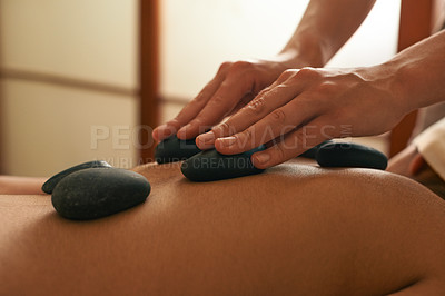 Buy stock photo Hands, spa and woman with hot stone back massage for health, wellness and beauty routine. Body care, relax and female person sleeping for warm rock therapy treatment at tranquil cosmetic salon.