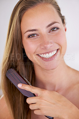 Buy stock photo A gorgeous brunette woman brushing her healthy long hair