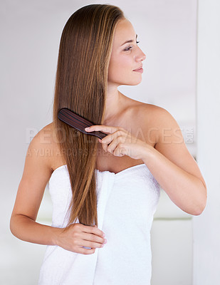 Buy stock photo Beauty, brush and hair care of woman in bathroom in home for cosmetics, cleaning or wellness for healthy growth. Hairstyle, towel or combing for morning routine, keratin treatment and person grooming