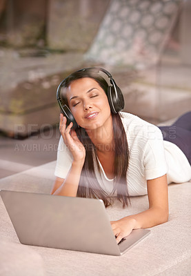 Buy stock photo Laptop, headphones and a woman listening to music on a home sofa with internet for streaming online. Happy female person relax on couch with tech to listen to audio, radio or podcast for peace