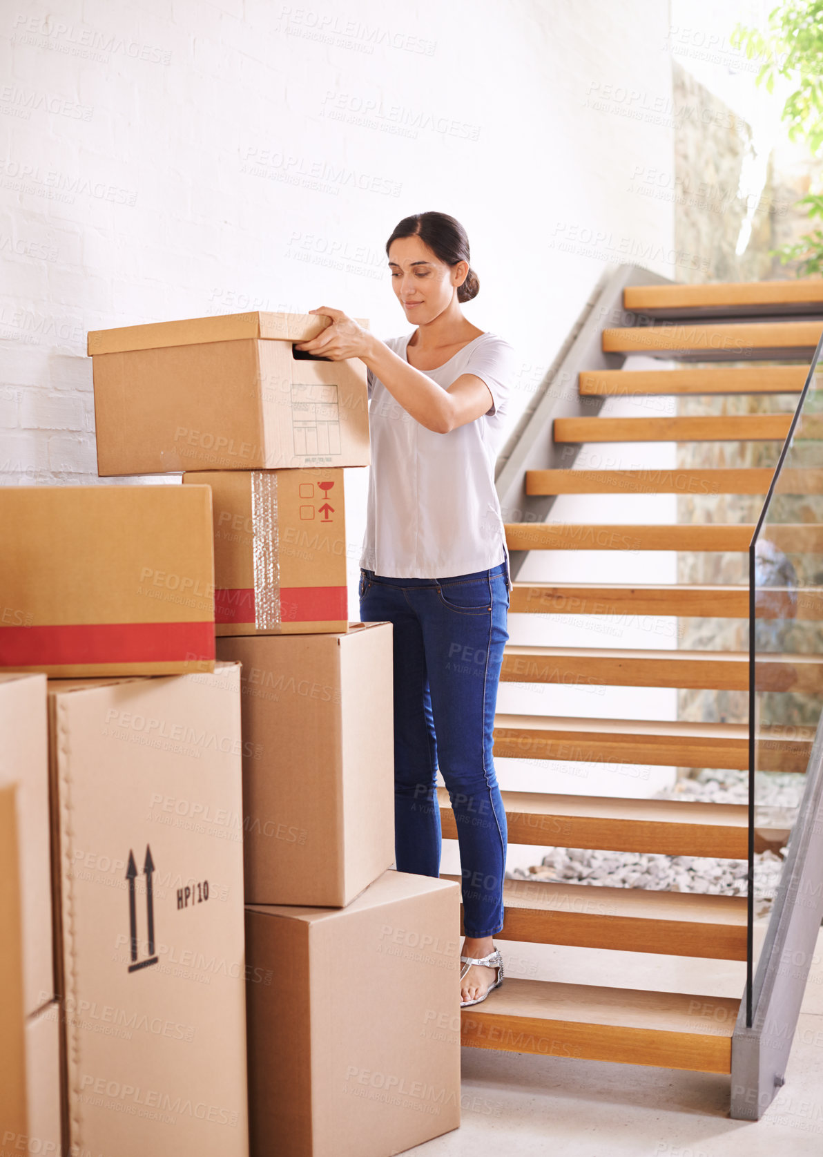 Buy stock photo Woman, new home and moving boxes for property investment, rental apartment or real estate loan. Smile, tenant and female person carrying cardboard package for logistics, relocation or renovation.