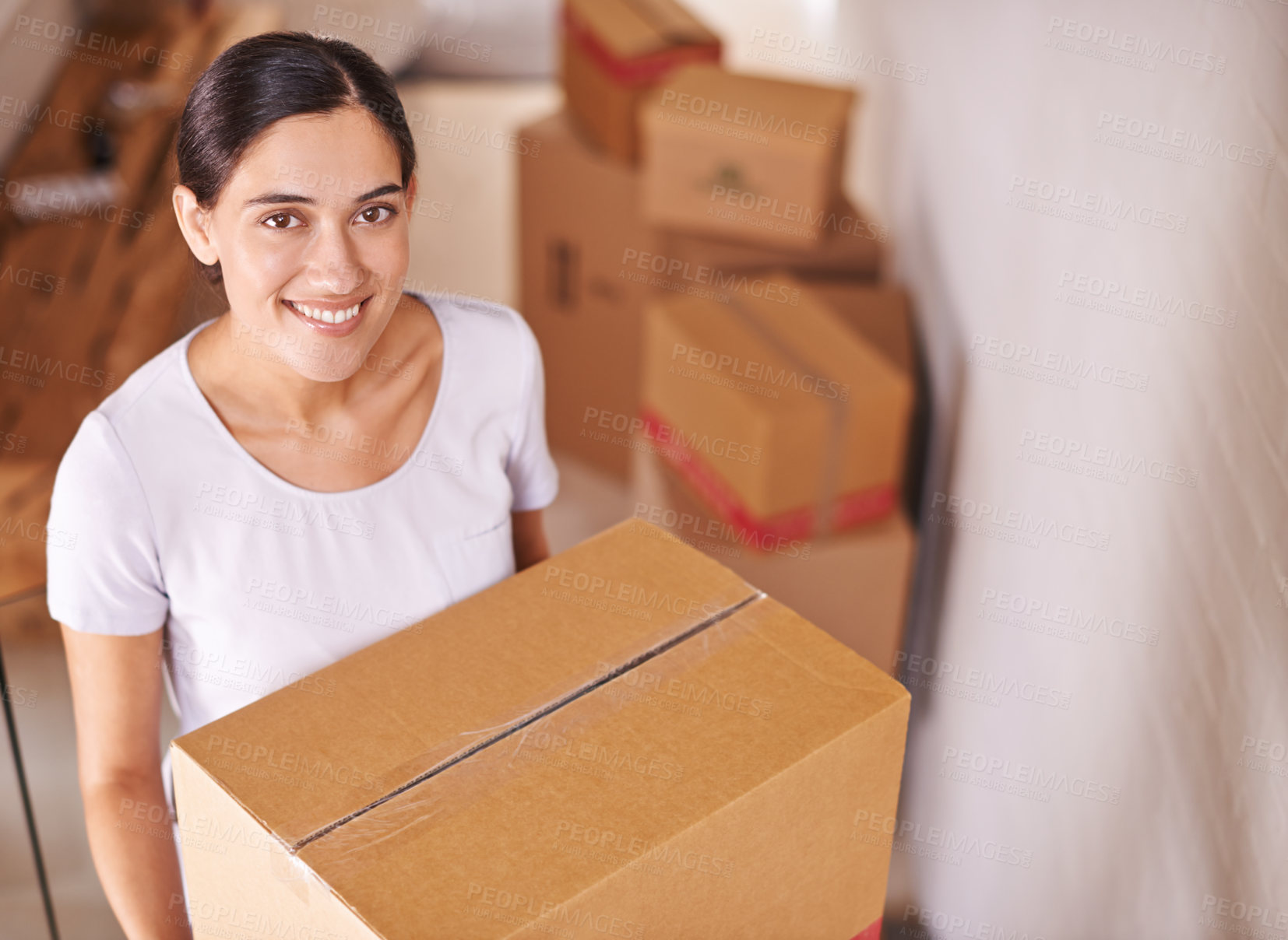 Buy stock photo A young woman surrounded by boxes