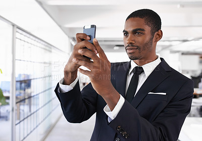 Buy stock photo Businessman, smile and selfie with smartphone in office for memory of job interview, confidence or social media post. Man, photography and company with pride for career, business or startup at work
