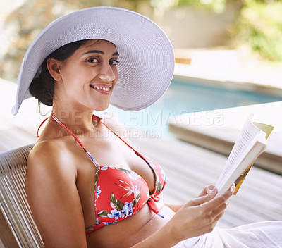 Buy stock photo Woman, relax and outdoor with book by poolside for reading on holiday or getaway on weekend in summer. Happy and tanned person with smile and novel bikini for swim and vacation for travel and rest 