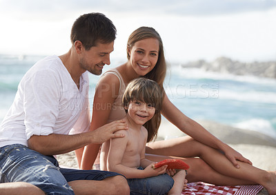 Buy stock photo Family, child and watermelon portrait at beach on travel holiday in summer with a smile for fun. A man, woman and kid eating fruit on a picnic while together on vacation at sea for happiness and care