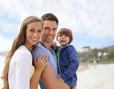 Buy stock photo Family, child and portrait outdoor at beach for travel, adventure or holiday in summer with a smile. A man, woman and kid or son together on vacation at sea with a blue sky, parents and happiness