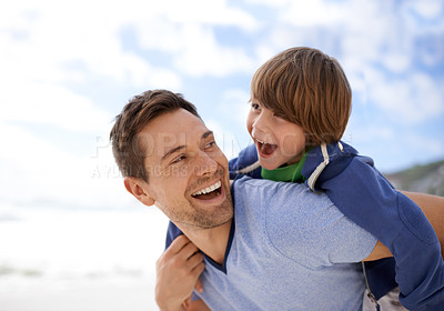 Buy stock photo Shot of a father and son spending quality time together at the beach