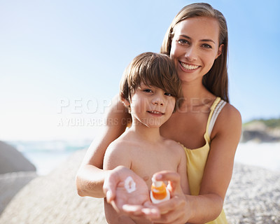 Buy stock photo Family, child or portrait at beach with sunscreen lotion on body for sun protection on travel or holiday in summer. A woman or mom and kid together on vacation at sea with smile, cream and happiness