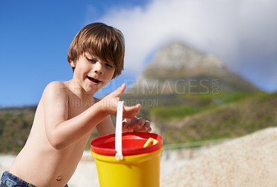 Buy stock photo Happy, beach and child with bucket and toys on summer holiday, vacation and relax by ocean. Childhood, building sand castle and young boy playing for adventure, fun and weekend by seaside in nature