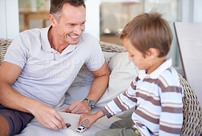 Buy stock photo Shot of a happy father playing with his son
