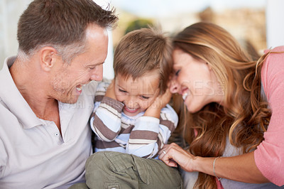 Buy stock photo Shot of parents tickling their young son