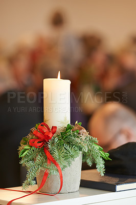Buy stock photo Christmas, religion and candle with mistletoe in church, bible and holy book or gospel on table for worship to God. Spiritual, faith and closeup of wax light to help Christian to pray for heaven