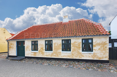 Buy stock photo Retro house, home and real estate in countryside with clouds, sky and building on street in Denmark. Vintage architecture, mortgage and Danish residence for lodging, living and old village in Europe