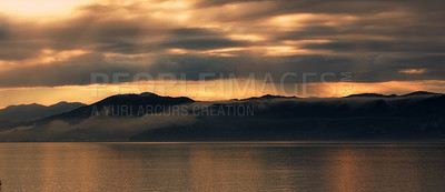 Buy stock photo Landscape, silhouette and sea by mountains or sunset background for environment, travel or adventure. Banner of the ocean in nature with clouds, winter and weather by hill in Wellington, New Zealand