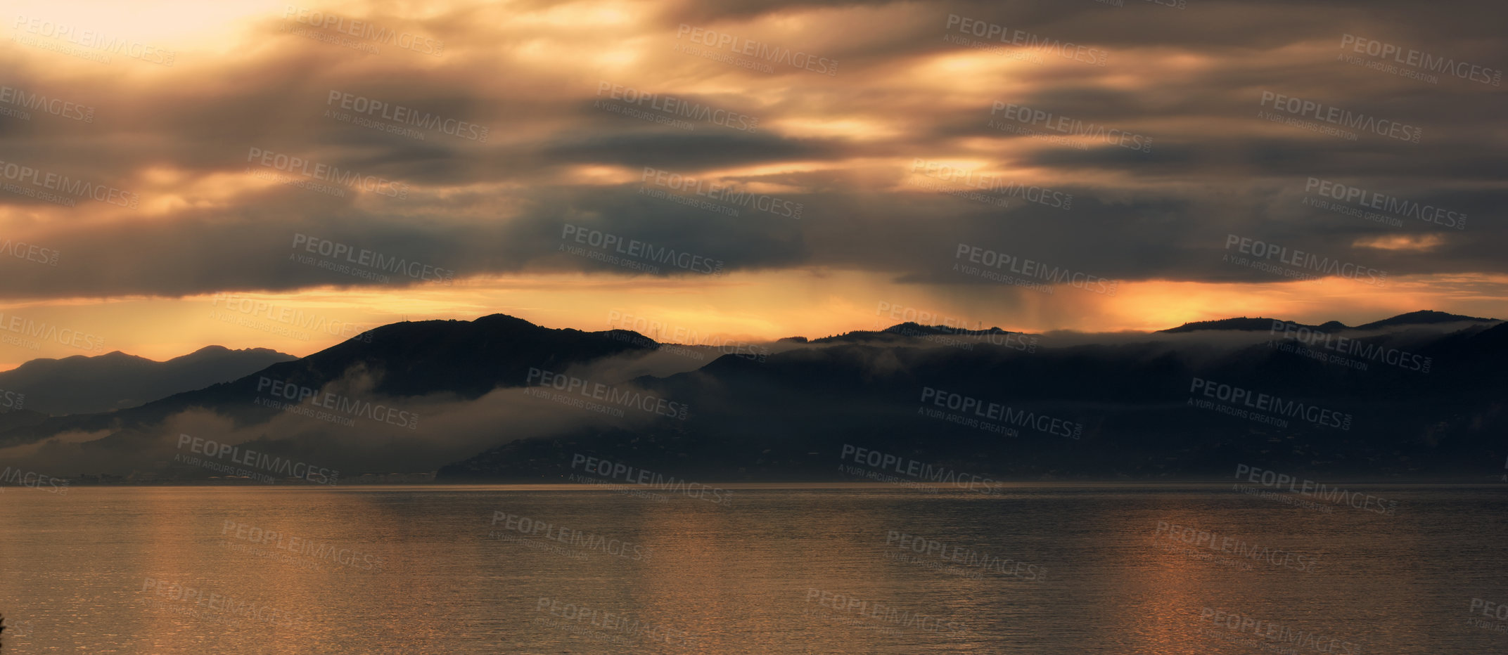 Buy stock photo Landscape, silhouette and sea by mountains or sunset background for environment, travel or adventure. Banner of the ocean in nature with clouds, winter and weather by hill in Wellington, New Zealand