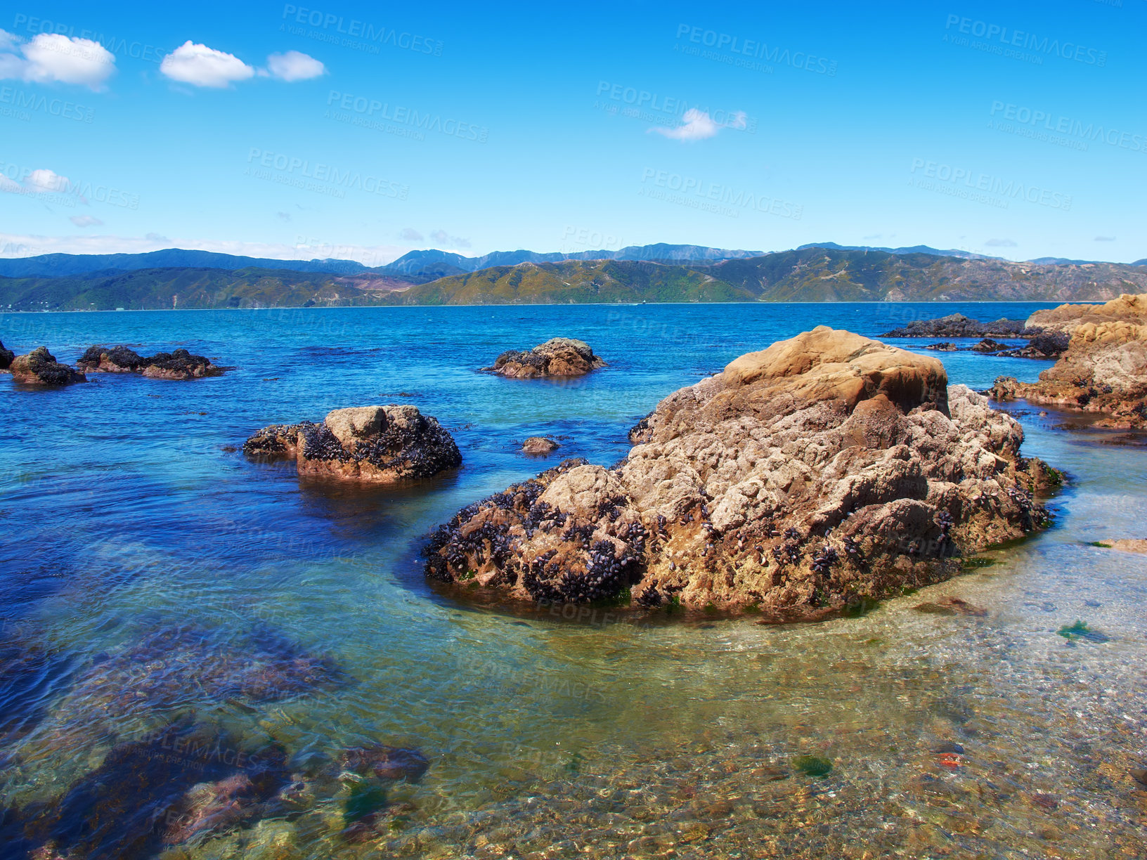 Buy stock photo Water, freedom and beach for travel, vacation or summer holiday, seascape or adventure in nature. Ocean, rock or boulder in New Zealand for tropical paradise, peace or relax with stress relief at sea
