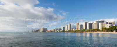 Buy stock photo Ocean, city and buildings with landscape, travel and destination with skyscraper and nature outdoor. Urban development, architecture and environment for tourism, adventure and location with blue sky