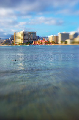 Buy stock photo Ocean, city blur and buildings with landscape, travel and destination with skyscraper and outdoor. Urban development, architecture and environment for tourism, adventure and location with blue sky