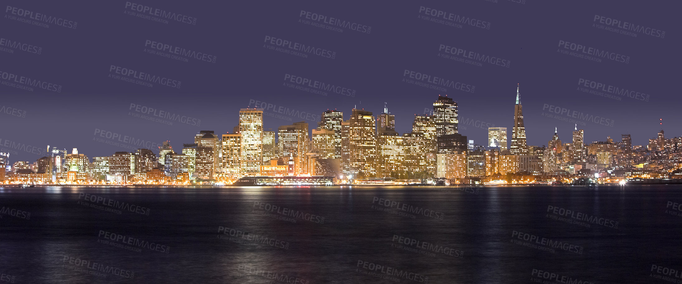 Buy stock photo Ocean, city at night and buildings with landscape, travel and destination with skyscraper and nature outdoor. Urban development, architecture and environment for tourism, adventure and location