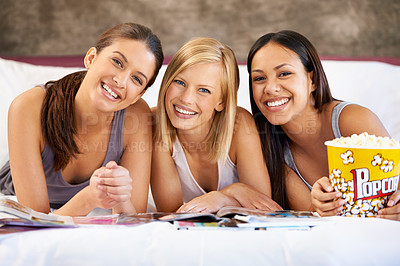 Buy stock photo Friends, popcorn and portrait for magazines, social and bedroom for bonding and excited group for snacks. Female people, together and sleepover for jokes, trust and entertainment with conversation 