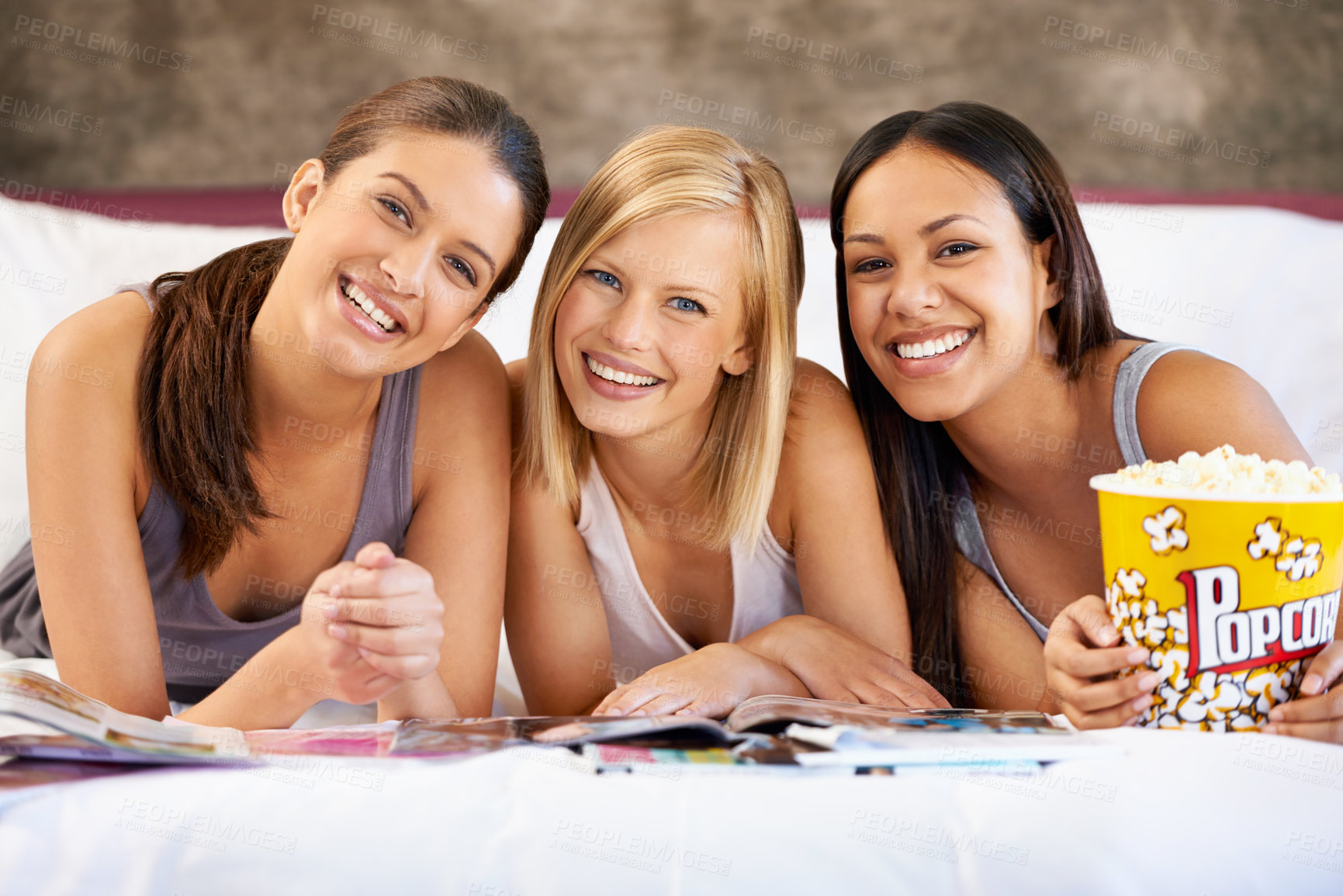 Buy stock photo Friends, popcorn and portrait for magazines, social and bedroom for bonding and excited group for snacks. Female people, together and sleepover for jokes, trust and entertainment with conversation 