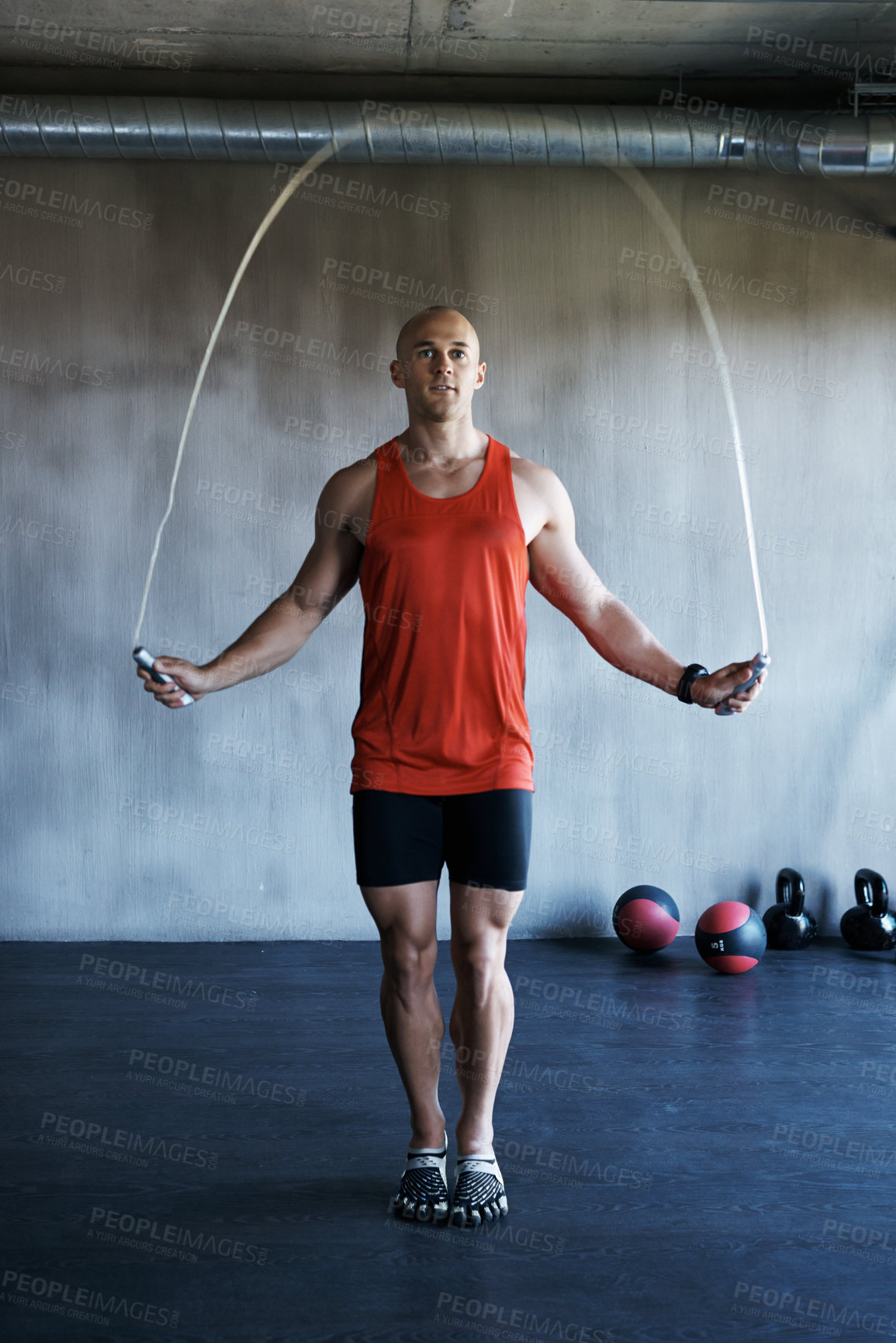 Buy stock photo Shot of a man training with a skipping rope at the gym