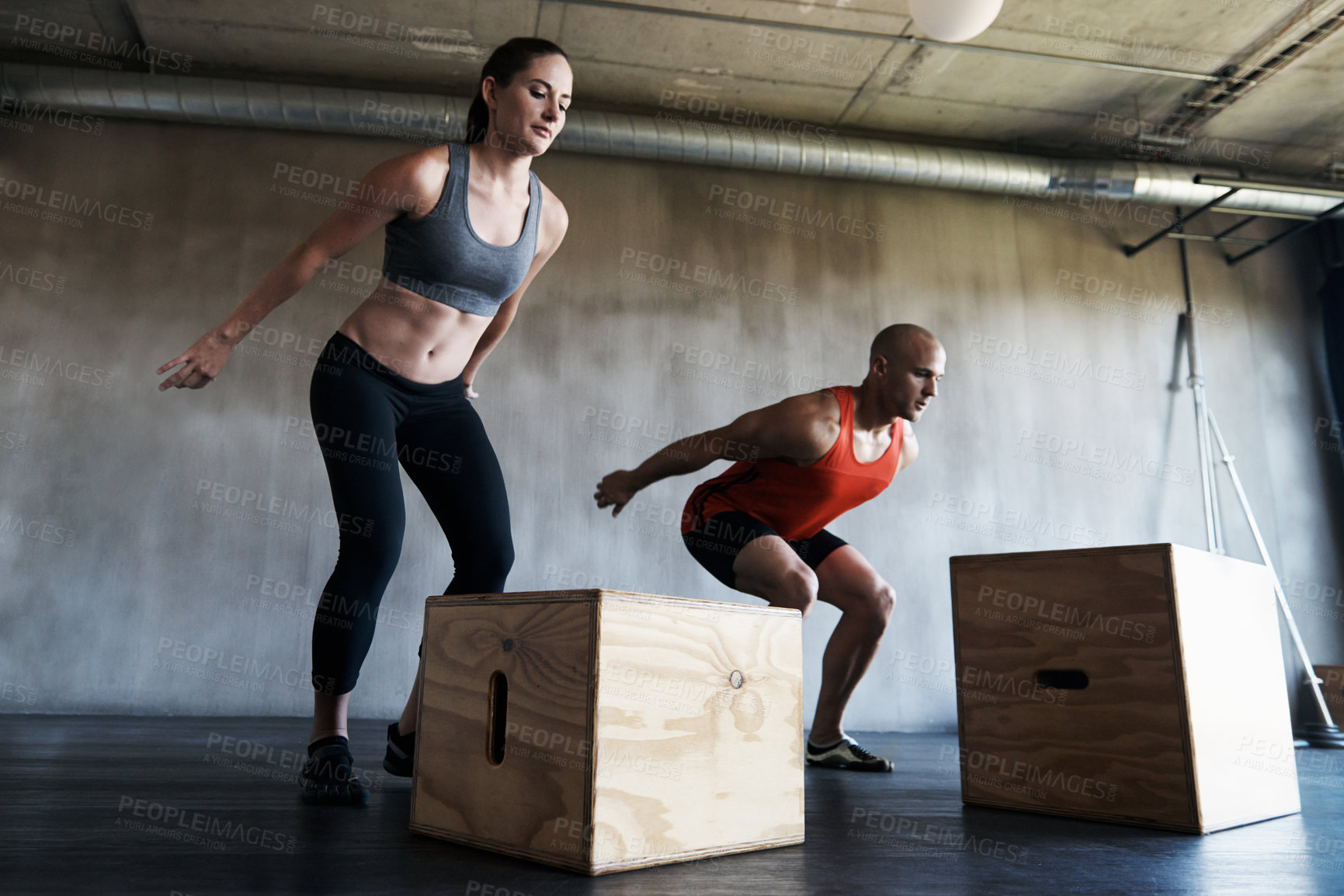 Buy stock photo Gym, couple and exercise with box jump for training, workout and intense cardio on wall background. Health, fitness and people at a sports center for wellness, performance and endurance challenge