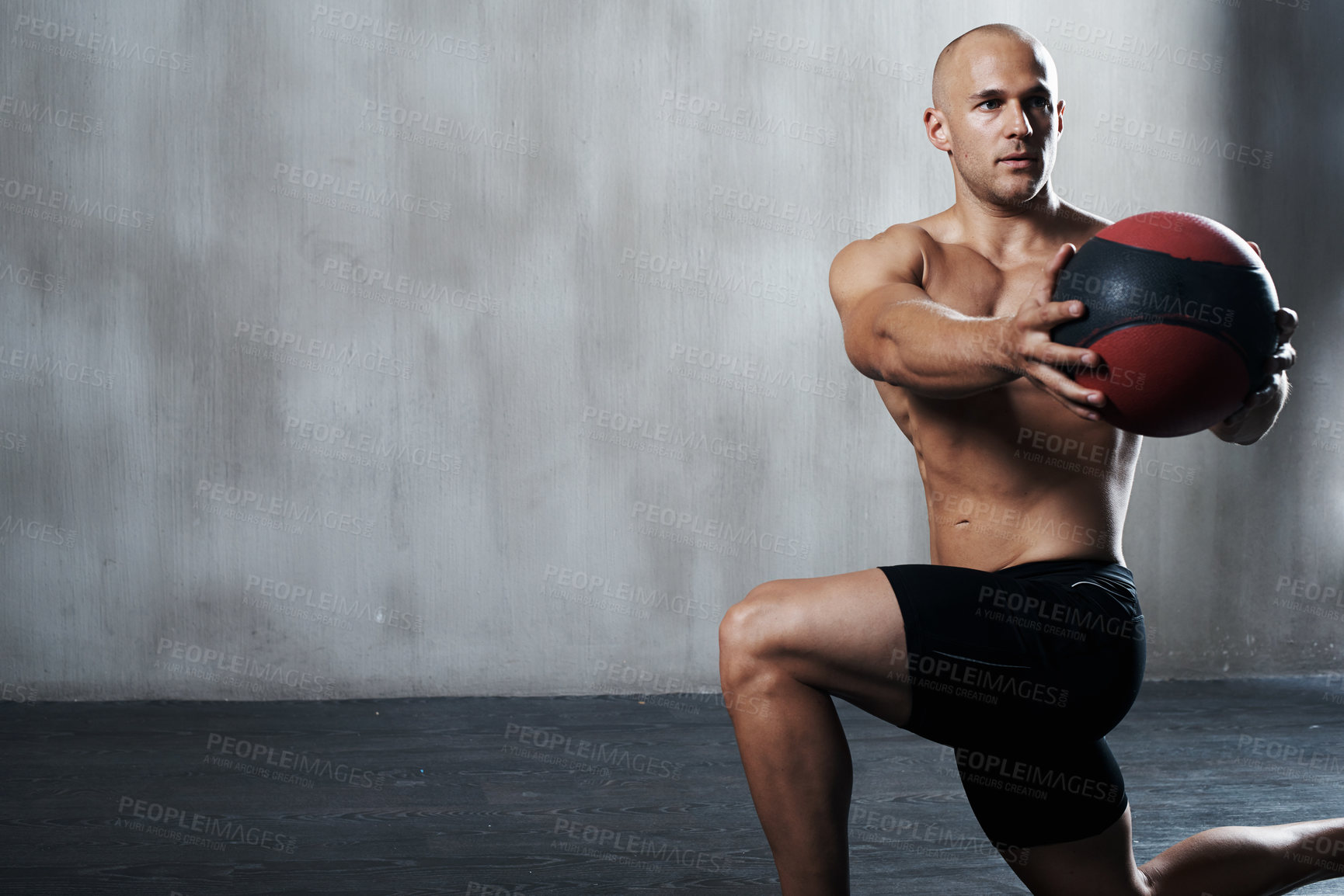 Buy stock photo Shot of a man working out with a medicine ball at the gym