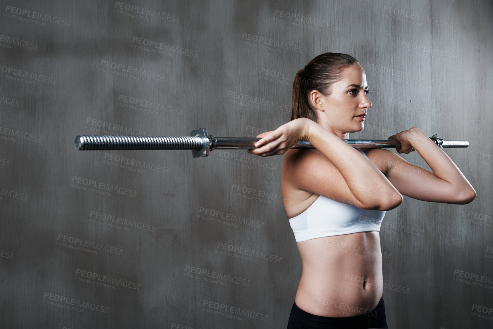 Buy stock photo Fitness, exercise and woman with barbell at gym for bodybuilding, strength or endurance on wall background. Weightlifting, training and female with strong mindset at sports center for intense workout