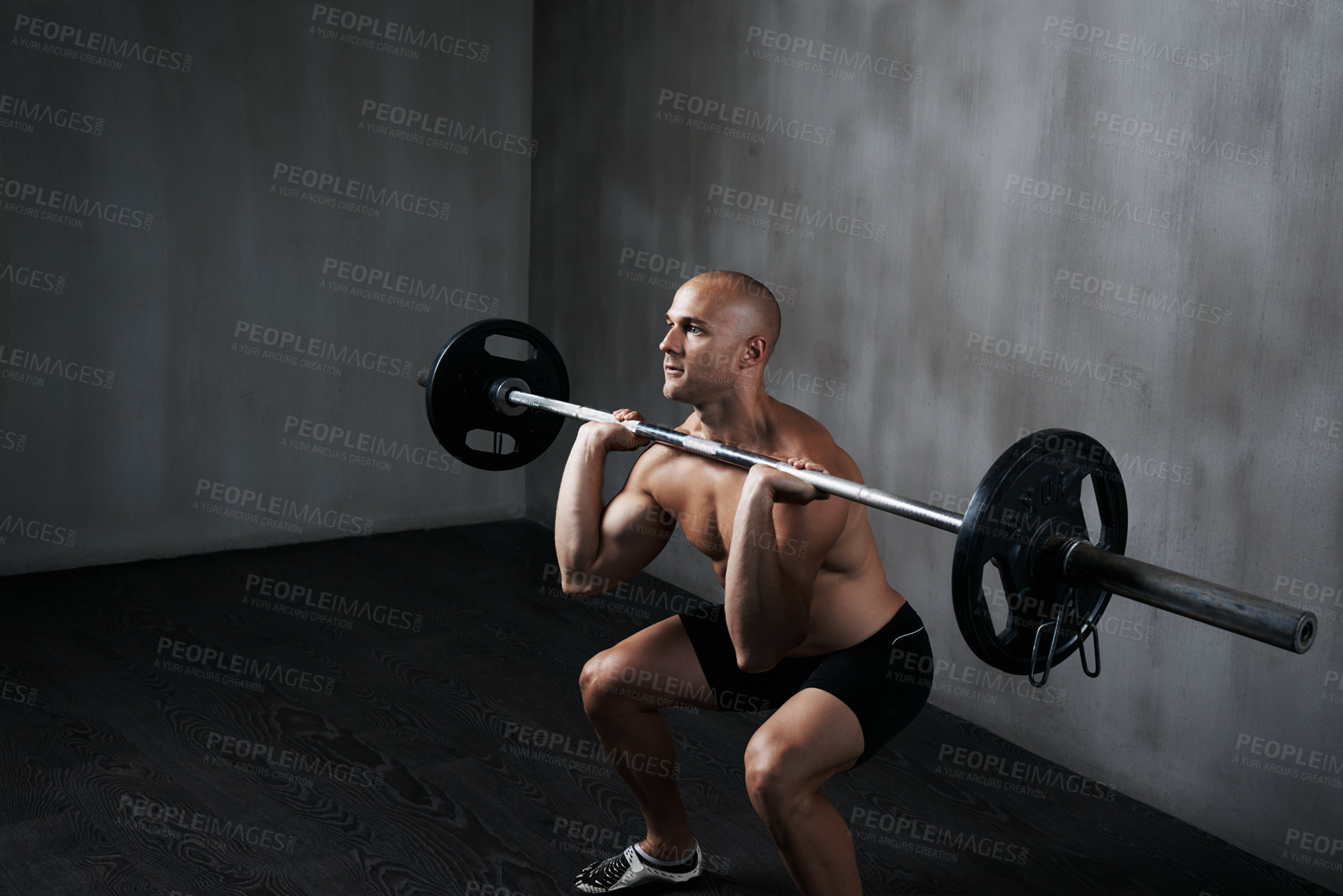 Buy stock photo Shot of a man working out with weights at the gym