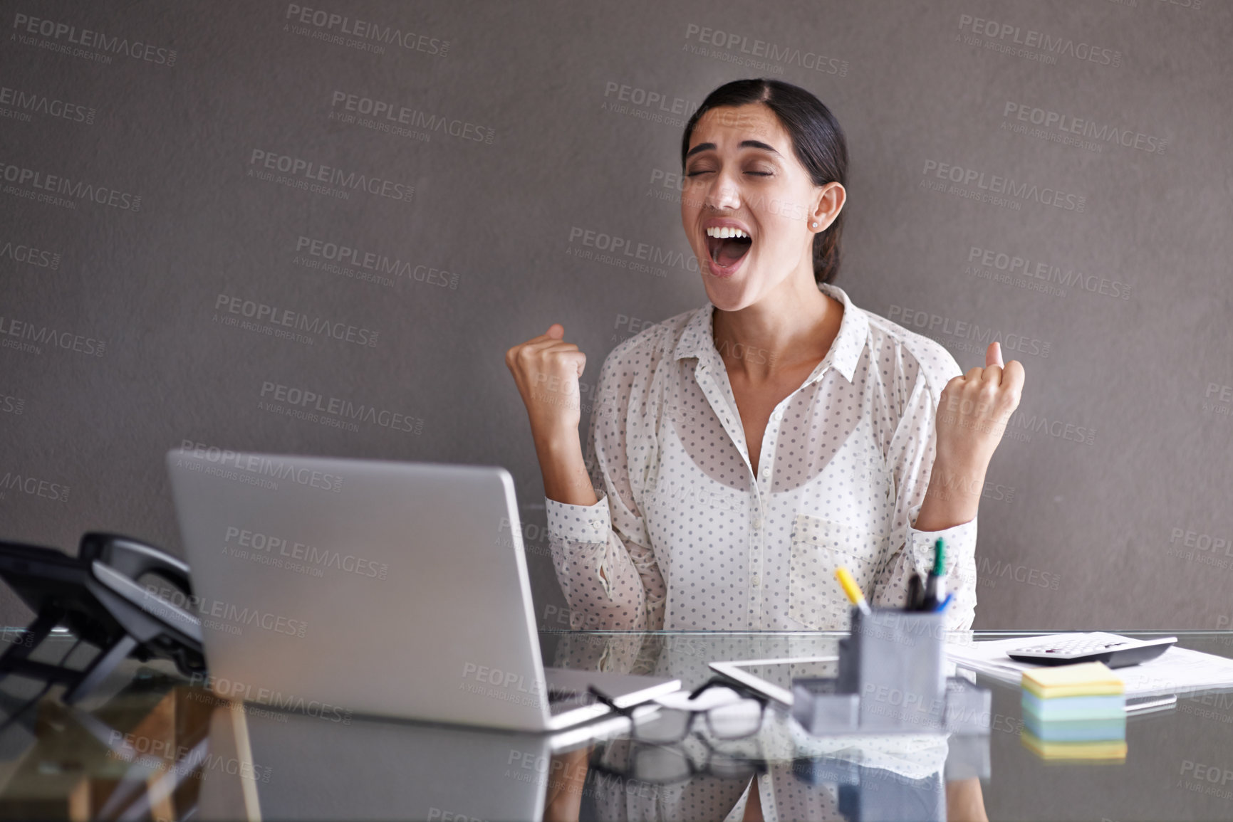 Buy stock photo Shot of a beautiful young woman celebrating at her laptop