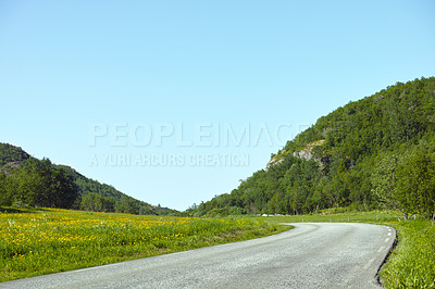 Buy stock photo Hill, road trip and natural landscape with field, holiday or green scenery in countryside. Nature, relax and highway for journey, vacation or outdoor adventure with blue sky, trees and mountain grass