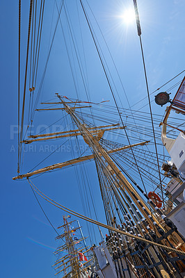 Buy stock photo Sailing, boat and mast outdoor with flag for travel, journey and low angle of blue sky in summer. Ship, wood pole and vintage schooner vessel on a cruise, rigging and transport in nature with rope