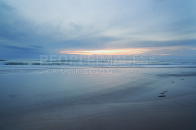 Buy stock photo A sunset over a desolate cloudy beach
