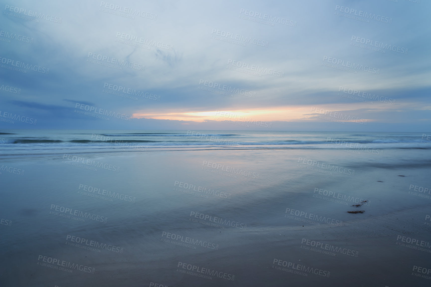 Buy stock photo A sunset over a desolate cloudy beach
