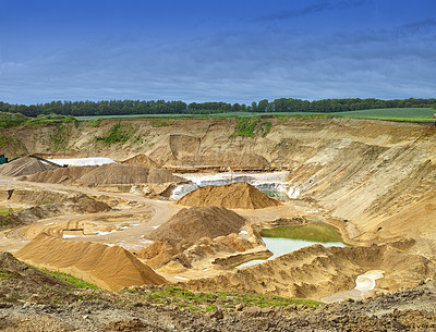 Buy stock photo An empty quarry landscape with water. Opencast mining quarry for copper, silver gold and other minerals. A danish quarry or deep pit, sand and clay textures surrounded by green grass and blue open sky